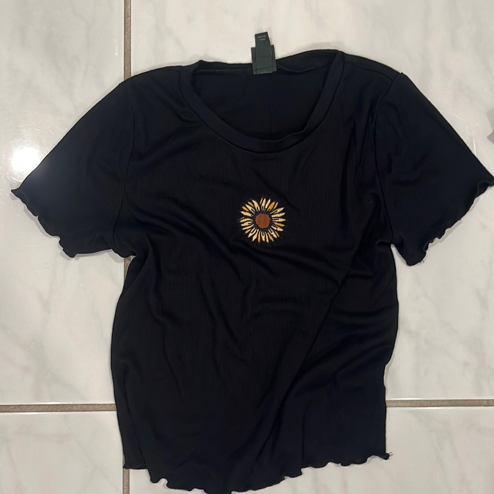 black shirt with a small sunflower